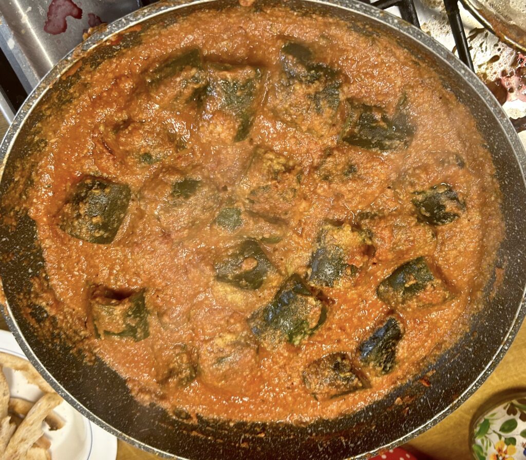 Add the remaining filling to the pan around the courgettes, add the wine