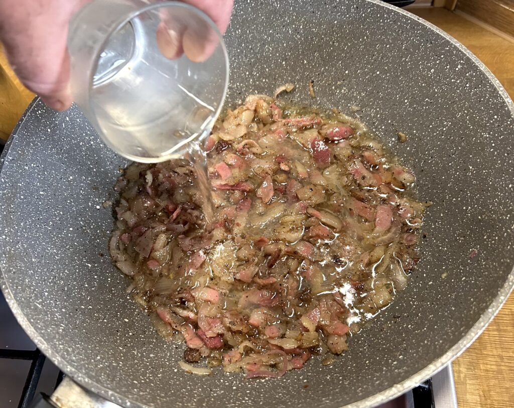 Add the white wine above guanciale