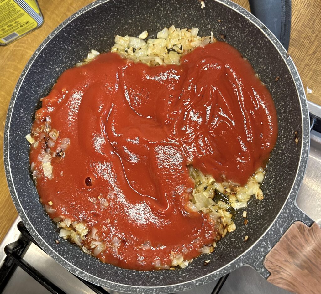 add the tomato puree