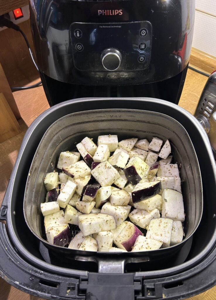 aubergine cubes in the lower part of the air fryer