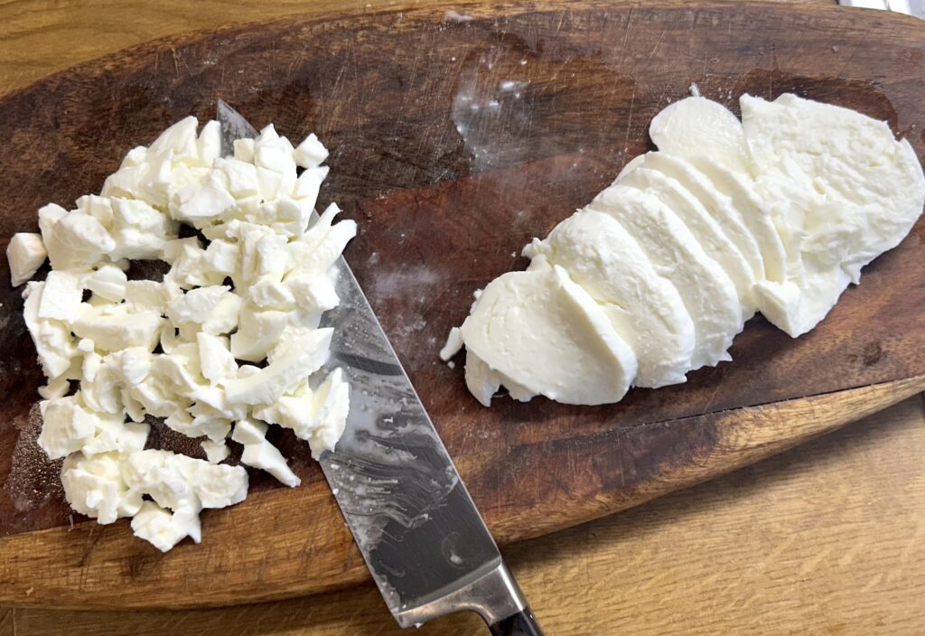 half part of mozzarella in a slice and the other half into small cubes