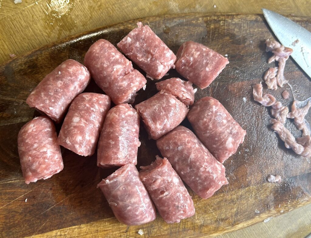 cut the 6 sausages in half and remove the skin