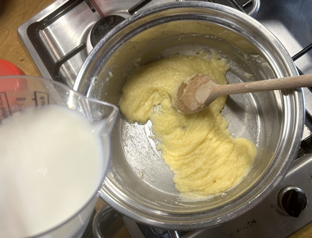 add hot milk to the butter and flour