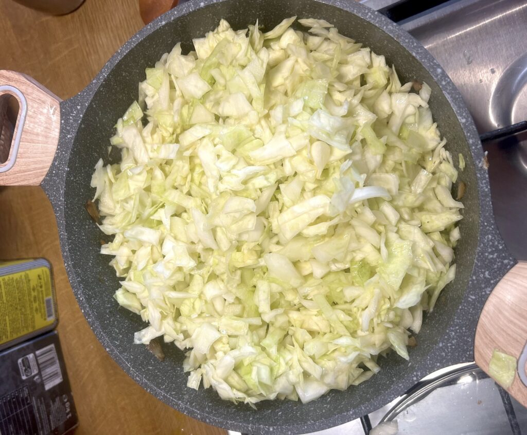 add the cabbage to the sausage