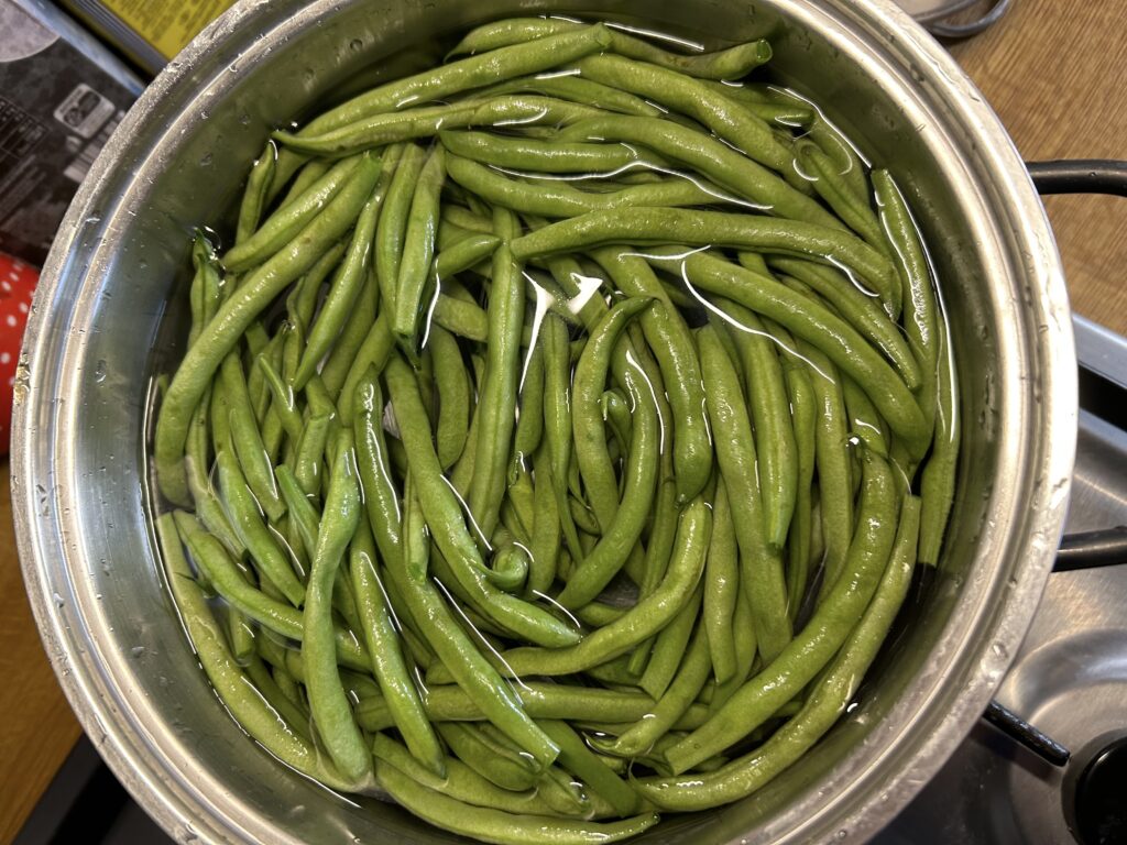 boil the green beans in a large pan