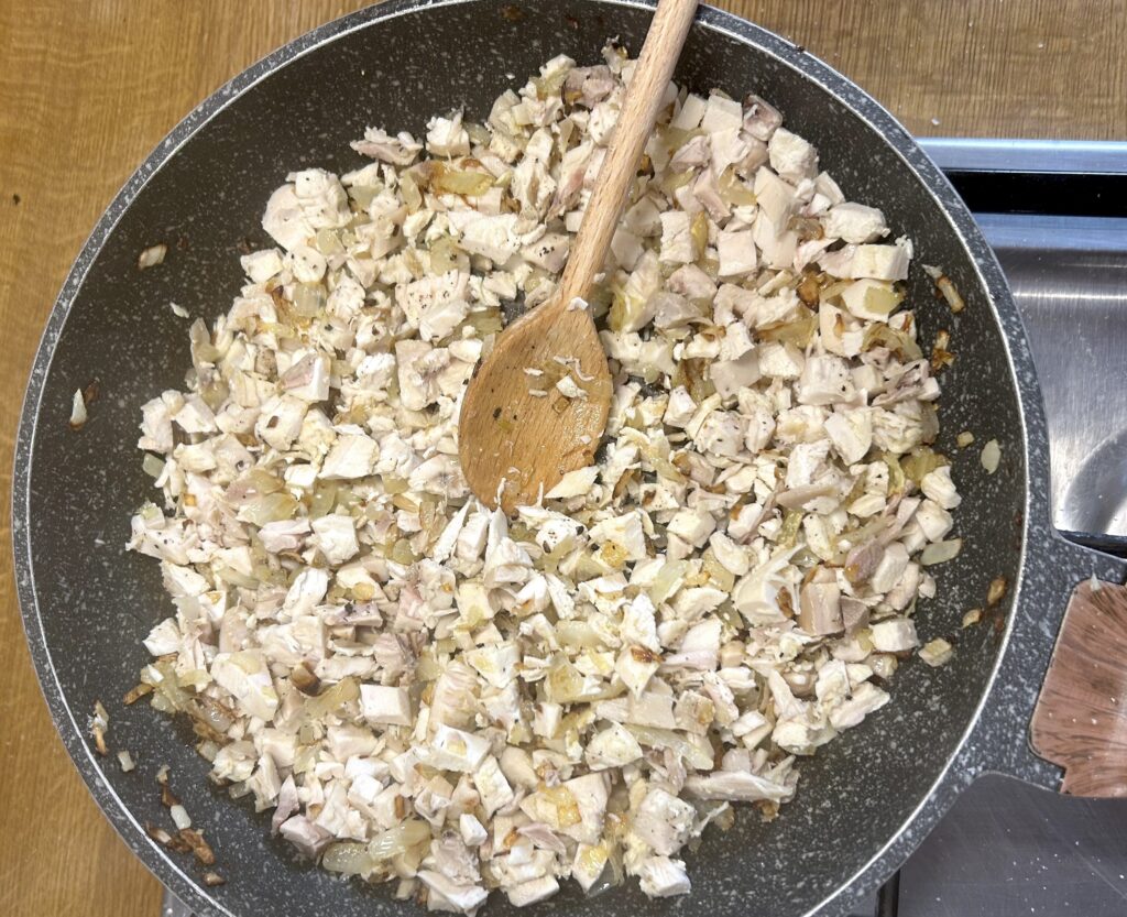 fried onion with pieces of chicken breast