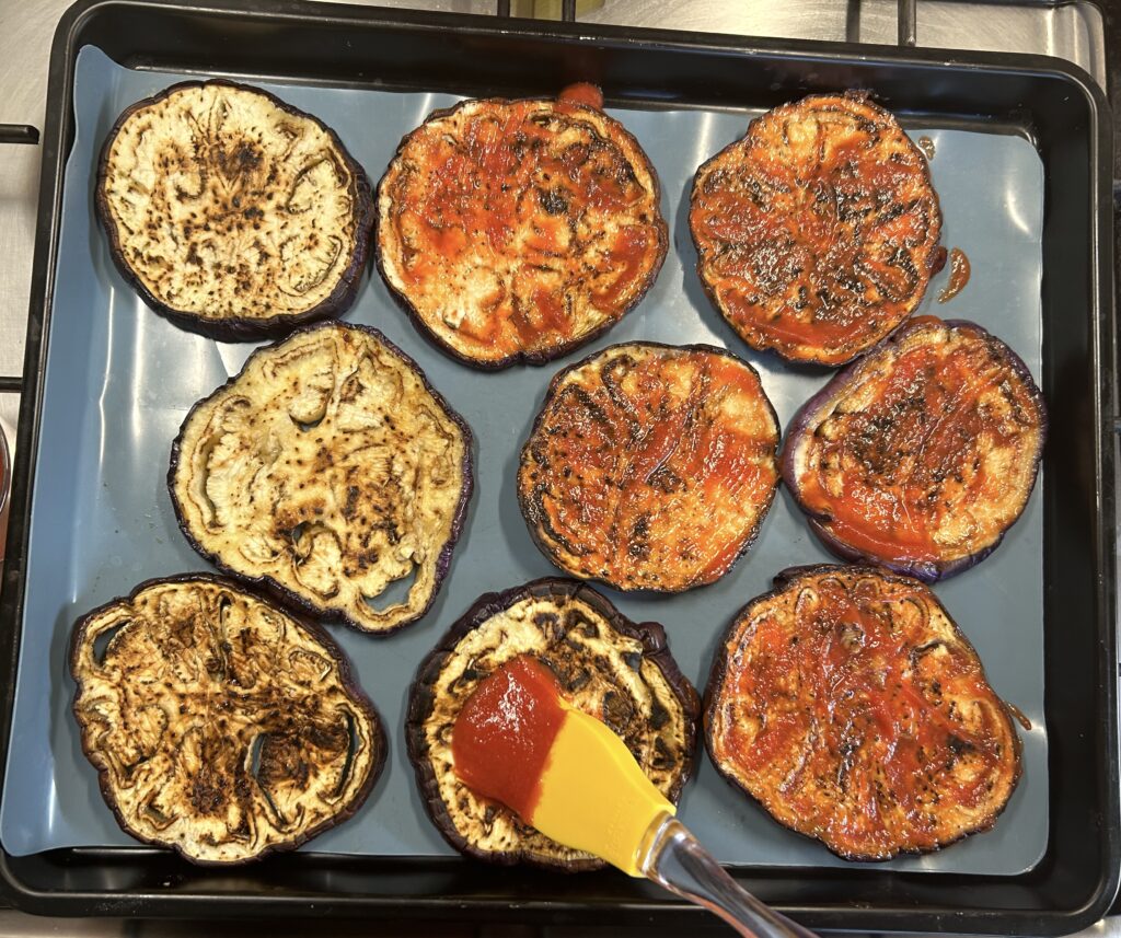 brush tomato puree over the eggplants slices