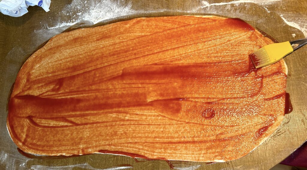 spread tomato puree on the pastry