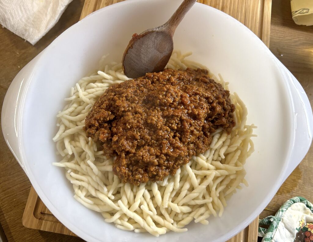 mix the trofie with the Bolognese ragù