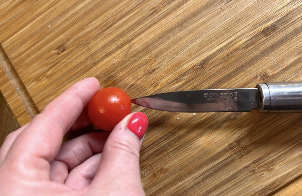 cut each cherry tomato