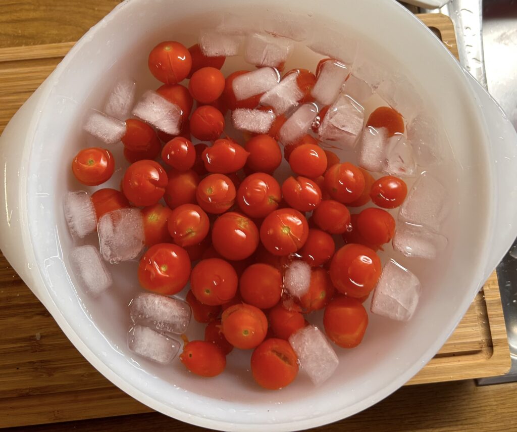 immerse tomato in a bowl with water and ice