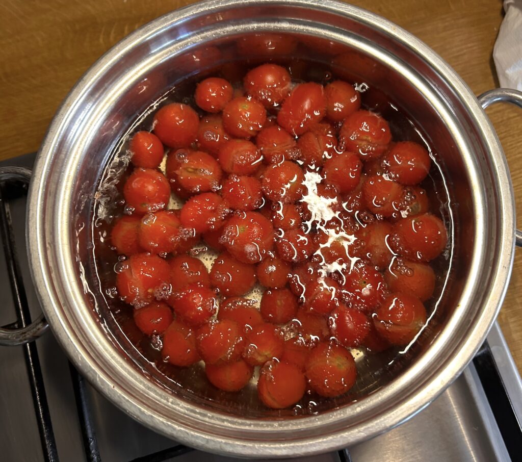 put tomato in a pan with water