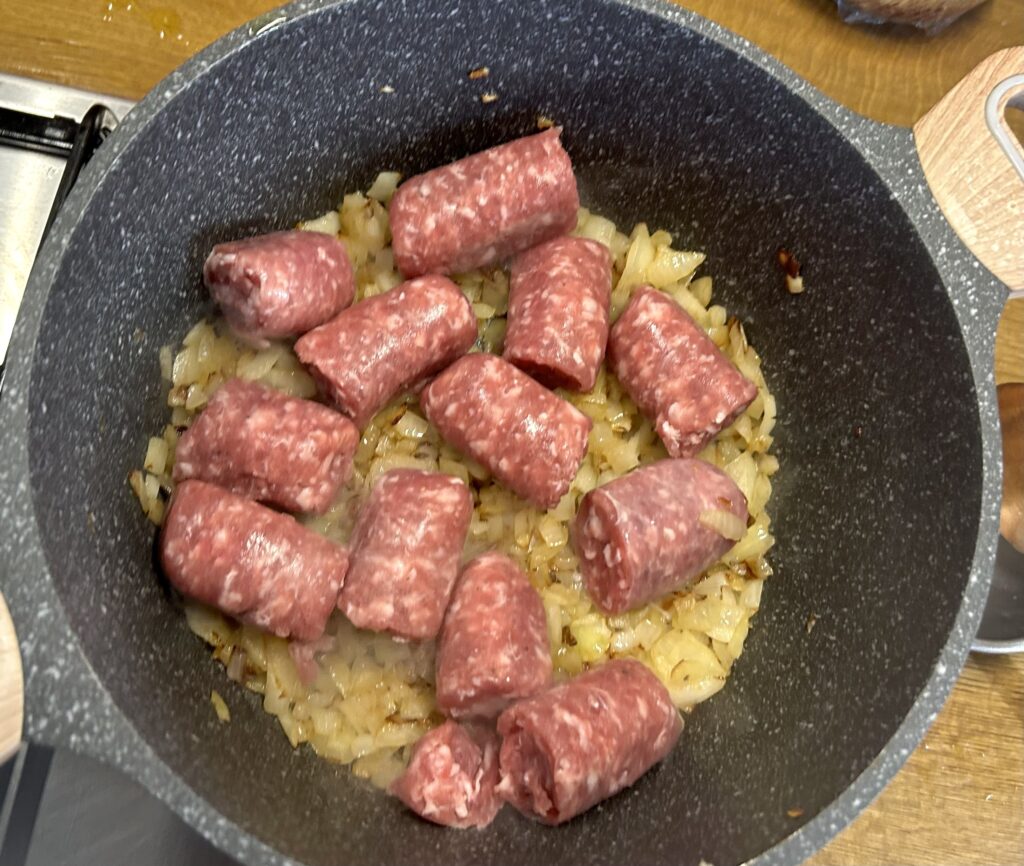 place the sausage pieces on top of the browned onion