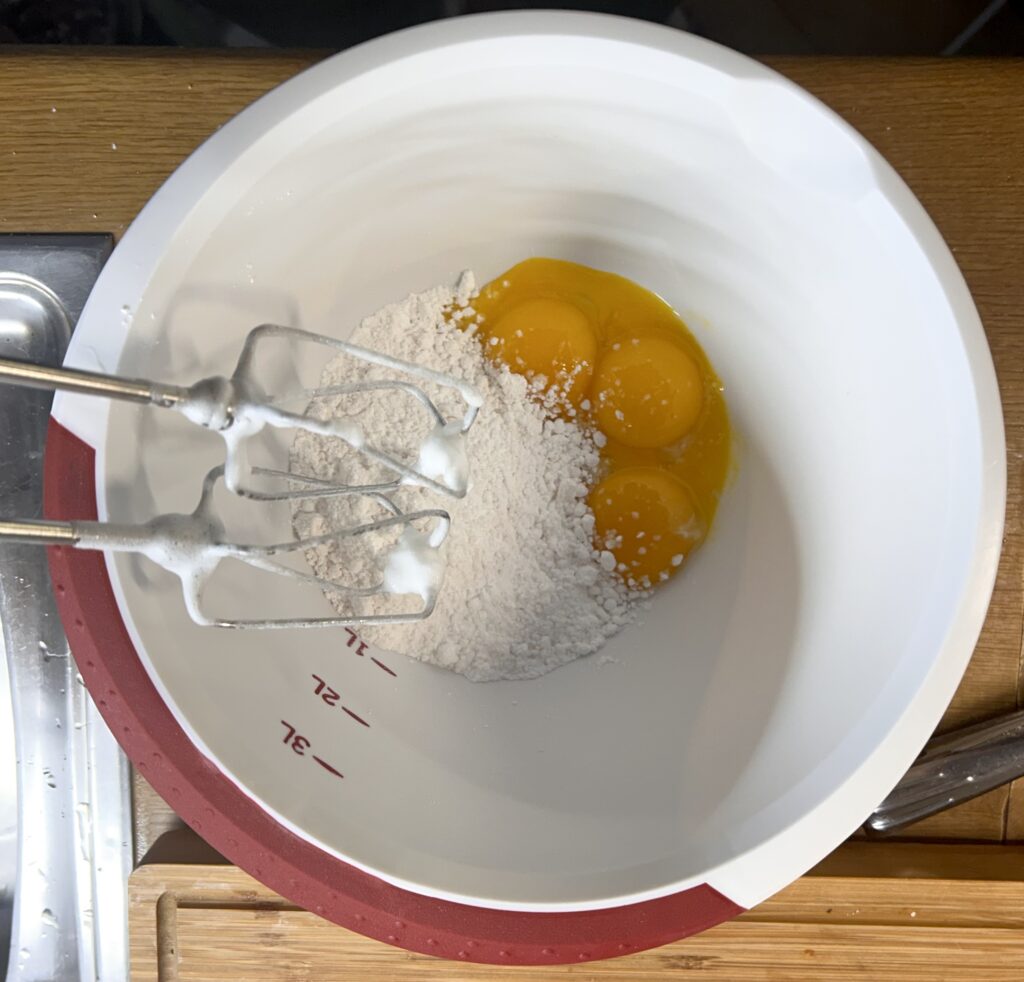 Whip egg yolks with icing sugar