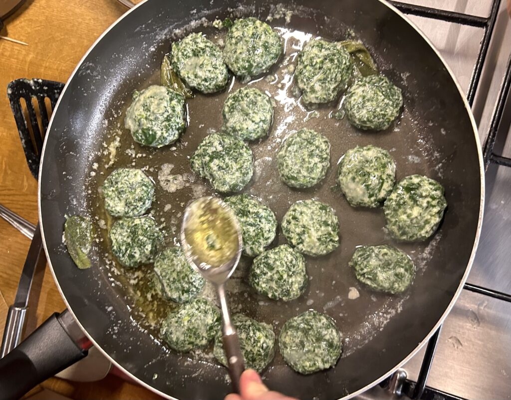 covering the meatballs with melted butter