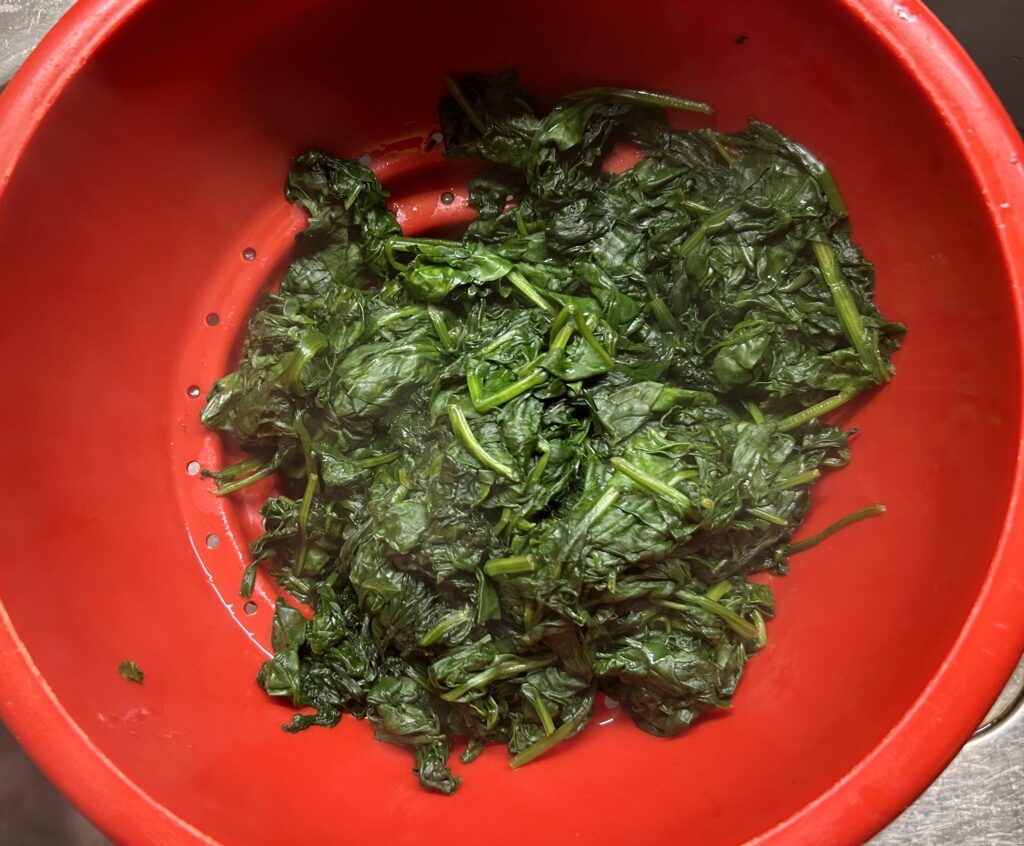 transfer the spinach to a colander